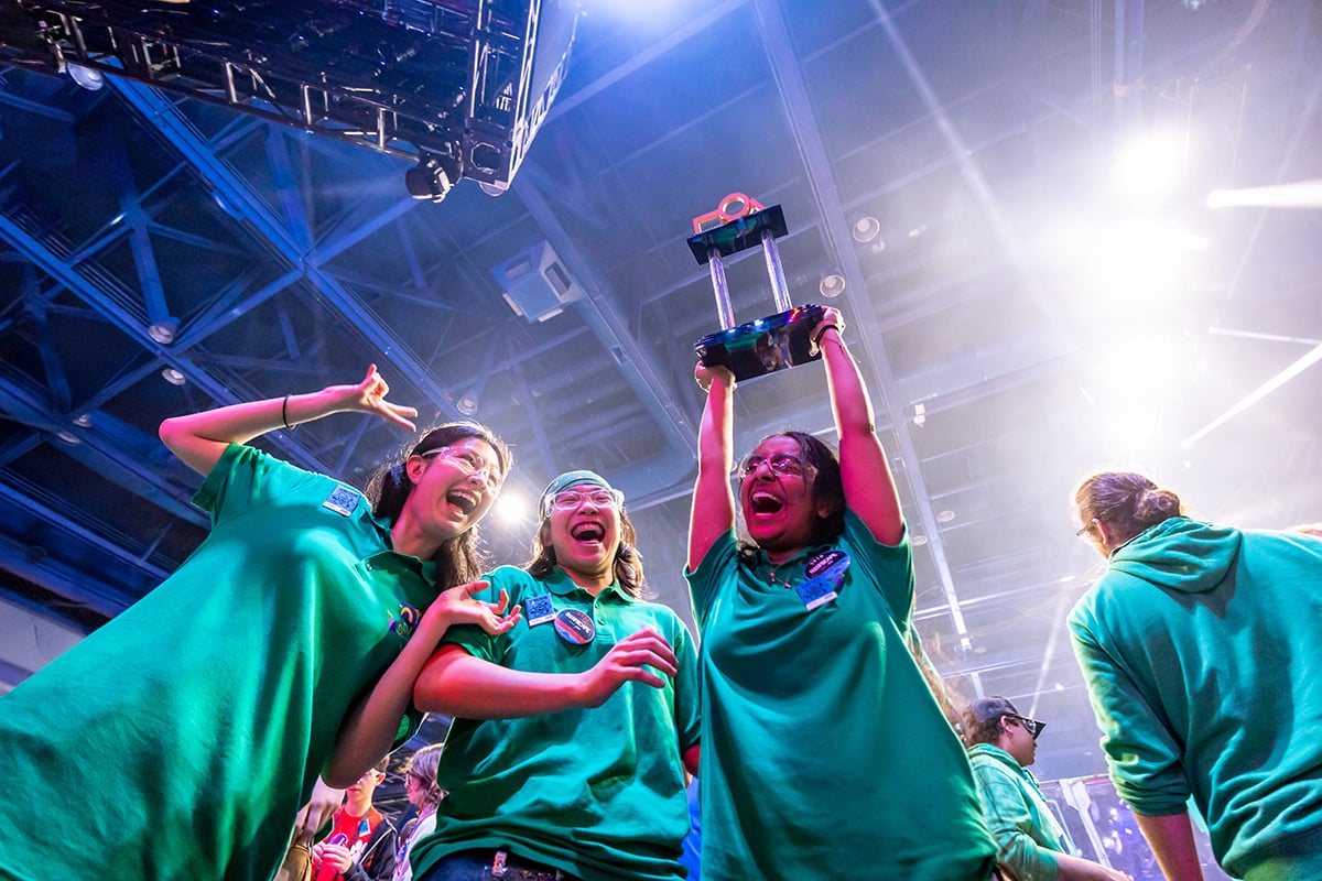 FIRST Robotics Competition students celebration and holding up trophy at FIRST Championship