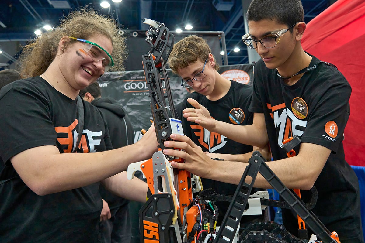 FIRST Robotics Competition students working on their robot at FIRST Championship