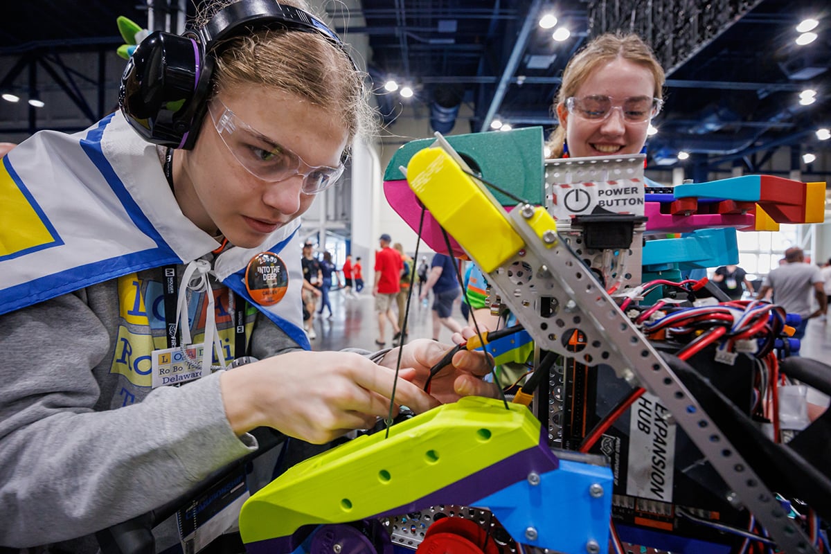 Two FIRST Tech Challenge students working on their robot at FIRST Championship