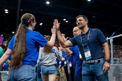 FIRST students high-five FIRST sponsor Dow