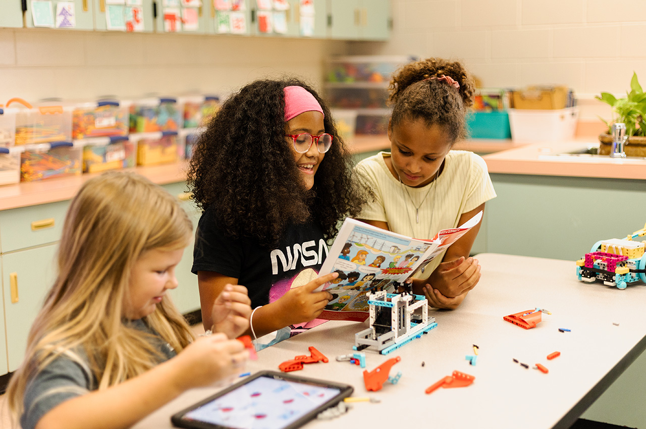 Students work with FIRST LEGO League materials in the classroom